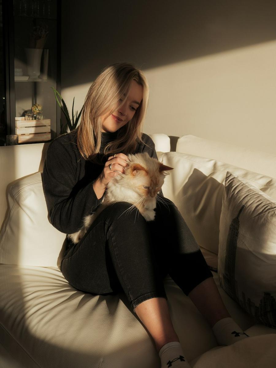 A woman cuddling her cat on the bed